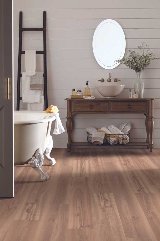wood look vinyl flooring in farmhouse style bathroom with greenery